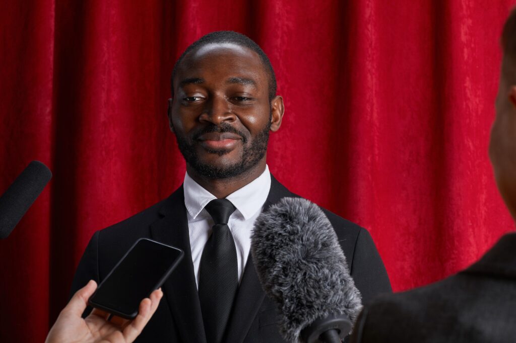 African-American Man Giving Interview to Journalists