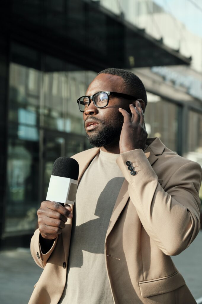 Reporter with microphone outdoors